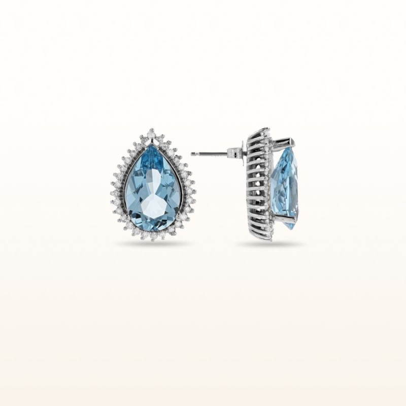 Pear Shaped Blue Topaz And Diamond Halo Stud Earrings In 14Kt White Gold